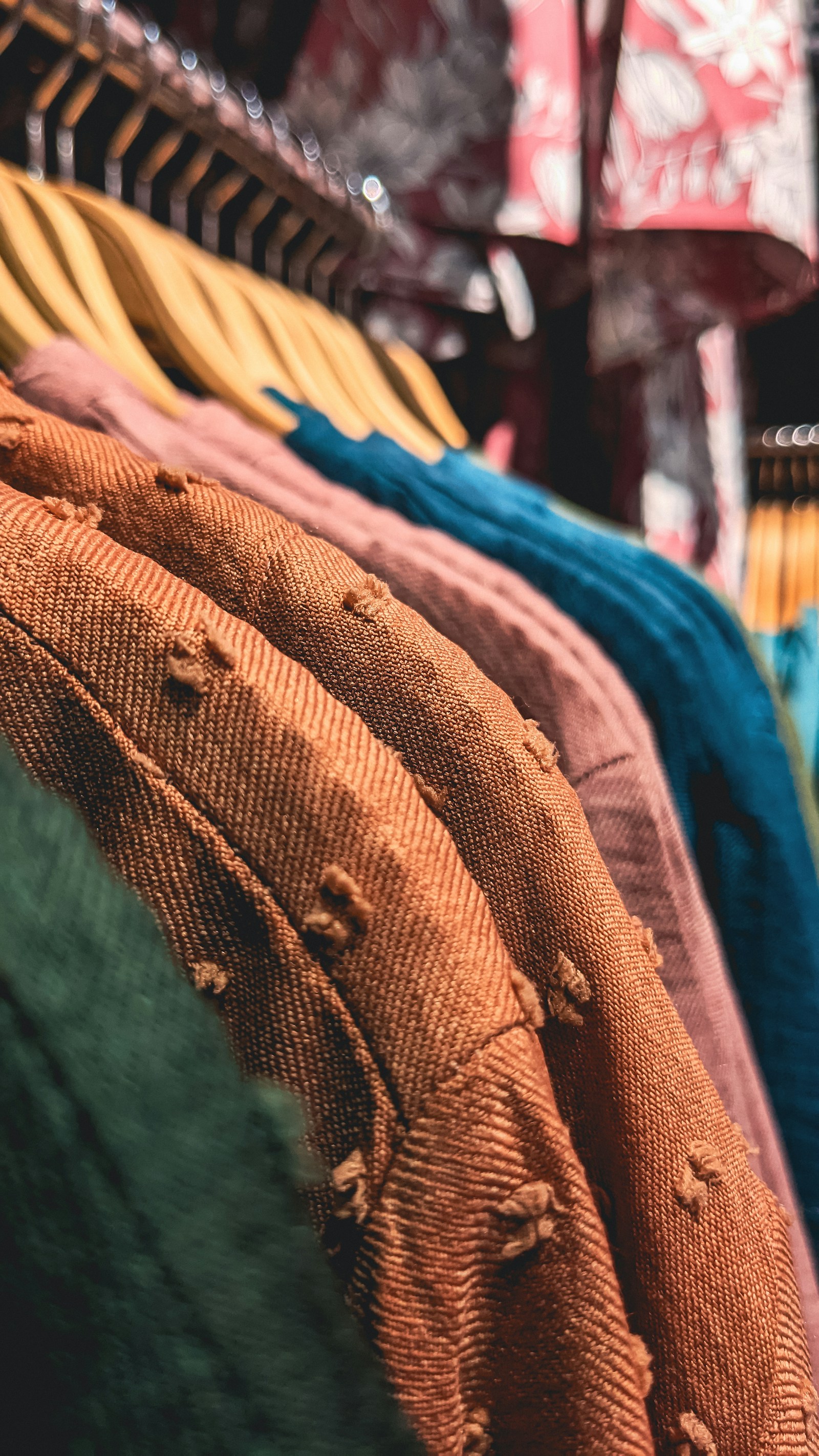 Colorful clothing arranged on a store rack